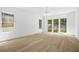 A spacious living room with hardwood floors, recessed lighting, and large windows at 819 Loridans Ne Dr, Atlanta, GA 30342