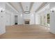 Cozy living room featuring hardwood floors, a fireplace, and a modern light fixture at 819 Loridans Ne Dr, Atlanta, GA 30342