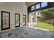 The exterior of a home featuring a covered patio with stone floors and two sets of black framed french doors at 819 Loridans Ne Dr, Atlanta, GA 30342