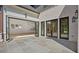 Exterior patio with stone floor and a view through folding glass doors into the home at 819 Loridans Ne Dr, Atlanta, GA 30342