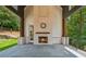 An outdoor patio featuring a stone fireplace and a view of the backyard at 819 Loridans Ne Dr, Atlanta, GA 30342