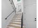Staircase with hardwood treads, black metal railing, and a landing mirror at 819 Loridans Ne Dr, Atlanta, GA 30342