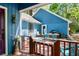 Back porch with outdoor dining, a grill, and a purple door, with a view of the trees at 1326 Janmar Rd, Snellville, GA 30078