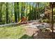 Backyard featuring a wooden playset with a slide and a basketball hoop at 1326 Janmar Rd, Snellville, GA 30078