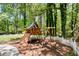 Backyard featuring a wooden playset with swings and a climbing wall by a white fence at 1326 Janmar Rd, Snellville, GA 30078