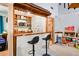 Unique basement bar featuring a sink, shelving, and seating, ideal for entertaining Gathering and friends at 1326 Janmar Rd, Snellville, GA 30078