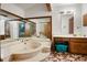 Spacious primary bathroom with a large soaking tub, vanity, and mirrored wall at 1326 Janmar Rd, Snellville, GA 30078