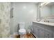 Bathroom featuring a modern vanity with a marble countertop and decorative shower curtain at 1326 Janmar Rd, Snellville, GA 30078