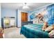 Vibrant bedroom featuring a Moana mural, plush bedding, and ample storage space at 1326 Janmar Rd, Snellville, GA 30078