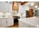 Bright kitchen featuring quartz counters, white cabinetry, stainless steel appliances, and light wood floors at 1326 Janmar Rd, Snellville, GA 30078