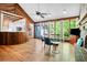 Bright living room featuring hardwood floors, large windows, and a view of the kitchen at 1326 Janmar Rd, Snellville, GA 30078
