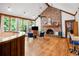 Bright living room featuring a brick fireplace, wooden floors, and ample natural light from large windows at 1326 Janmar Rd, Snellville, GA 30078