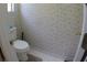 Small bathroom with floral wallpaper, white toilet and tile floor at 545 Chaseridge Dr, Mcdonough, GA 30253