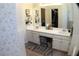 Bathroom showcasing a double sink vanity, patterned wallpaper, and tile floor at 545 Chaseridge Dr, Mcdonough, GA 30253