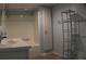 Bright bathroom features a white sink, vanity, shower, and storage shelf at 545 Chaseridge Dr, Mcdonough, GA 30253