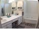Bathroom featuring a soaking tub, dual sinks, and vanity with storage at 545 Chaseridge Dr, Mcdonough, GA 30253