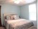 This bedroom features natural light and a bed with decorative pillows and patterned comforter at 545 Chaseridge Dr, Mcdonough, GA 30253