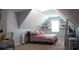 Attic bedroom with a bed, shelves and modern decor at 545 Chaseridge Dr, Mcdonough, GA 30253