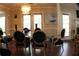 Elegant dining room featuring a glass table with black upholstered chairs, and stylish chandelier at 545 Chaseridge Dr, Mcdonough, GA 30253
