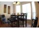 Bright dining area with bay windows, chandelier, dark wood table, and seating at 545 Chaseridge Dr, Mcdonough, GA 30253