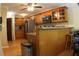 Traditional kitchen with oak cabinets, stainless appliances, and breakfast bar overlooking wood floors at 545 Chaseridge Dr, Mcdonough, GA 30253