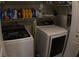 Washer and dryer in a laundry room, complete with shelves and detergent at 545 Chaseridge Dr, Mcdonough, GA 30253