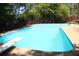 Refreshing in-ground pool with diving board and fenced-in area, providing a fun and secure outdoor space at 545 Chaseridge Dr, Mcdonough, GA 30253