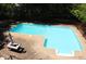 Inviting in-ground pool surrounded by a concrete patio, perfect for outdoor relaxation and entertaining at 545 Chaseridge Dr, Mcdonough, GA 30253