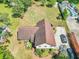 Aerial view of home showcasing mature trees, back patio, and driveway at 9082 Chestnut Lake Dr, Jonesboro, GA 30236