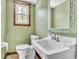 This charming bathroom features sage walls, a classic sink, and a decorative mirror at 9082 Chestnut Lake Dr, Jonesboro, GA 30236