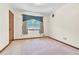 Bright bedroom with neutral walls, carpet, and decorative window treatments at 9082 Chestnut Lake Dr, Jonesboro, GA 30236