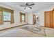 Bright primary bedroom featuring neutral walls, ceiling fan, and ensuite bathroom access at 9082 Chestnut Lake Dr, Jonesboro, GA 30236
