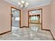 Dining room features tiled floors and a chandelier, adjacent to the living room at 9082 Chestnut Lake Dr, Jonesboro, GA 30236