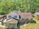 Back exterior of home featuring screened in porch, brick facade and partial wooded lot at 9082 Chestnut Lake Dr, Jonesboro, GA 30236