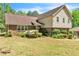 Charming home featuring brick accents, a manicured lawn, and lush landscaping at 9082 Chestnut Lake Dr, Jonesboro, GA 30236