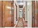 Long hallway with multiple doors featuring vintage carpet with red accents at 9082 Chestnut Lake Dr, Jonesboro, GA 30236