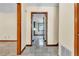 Hallway featuring tiled floors and wood trim, connecting various rooms in the home at 9082 Chestnut Lake Dr, Jonesboro, GA 30236
