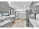 Updated kitchen features grey cabinets, stainless appliances, marble countertops, and bright, patterned tile floor at 9082 Chestnut Lake Dr, Jonesboro, GA 30236