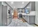 Updated kitchen showcases stylish stainless steel appliances, modern gray cabinetry, and marble tiled floors at 9082 Chestnut Lake Dr, Jonesboro, GA 30236