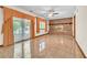 Bright living room showcases a brick fireplace, ceiling fan, and sliding glass doors at 9082 Chestnut Lake Dr, Jonesboro, GA 30236