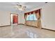 Bright living room with elegant tiled floors and large window with drapes at 9082 Chestnut Lake Dr, Jonesboro, GA 30236