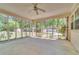 Covered screened-in porch with ceiling fan offers backyard views at 9082 Chestnut Lake Dr, Jonesboro, GA 30236