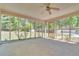 Relaxing screened-in porch with ceiling fan and views of the backyard at 9082 Chestnut Lake Dr, Jonesboro, GA 30236