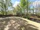 Large backyard with mature trees, a picnic table, and a partially-wooded area at 2585 Chandler Grove Dr, Buford, GA 30519