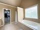 Bathroom featuring soaker tub, walk in closet, and natural light at 2585 Chandler Grove Dr, Buford, GA 30519