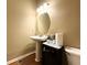 Bathroom with pedestal sink, decorative mirror, and neutral color palette at 2585 Chandler Grove Dr, Buford, GA 30519