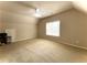 Spacious bedroom featuring a ceiling fan and a large window letting in plenty of natural light at 2585 Chandler Grove Dr, Buford, GA 30519
