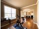 Bedroom features hardwood floors, trim, an exercise bike, and view into the dining room at 2585 Chandler Grove Dr, Buford, GA 30519