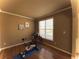 Bedroom features hardwood floors, trim and a large window with lots of natural light at 2585 Chandler Grove Dr, Buford, GA 30519