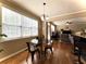 Bright dining area features hardwood floors, a modern light fixture, and large windows at 2585 Chandler Grove Dr, Buford, GA 30519